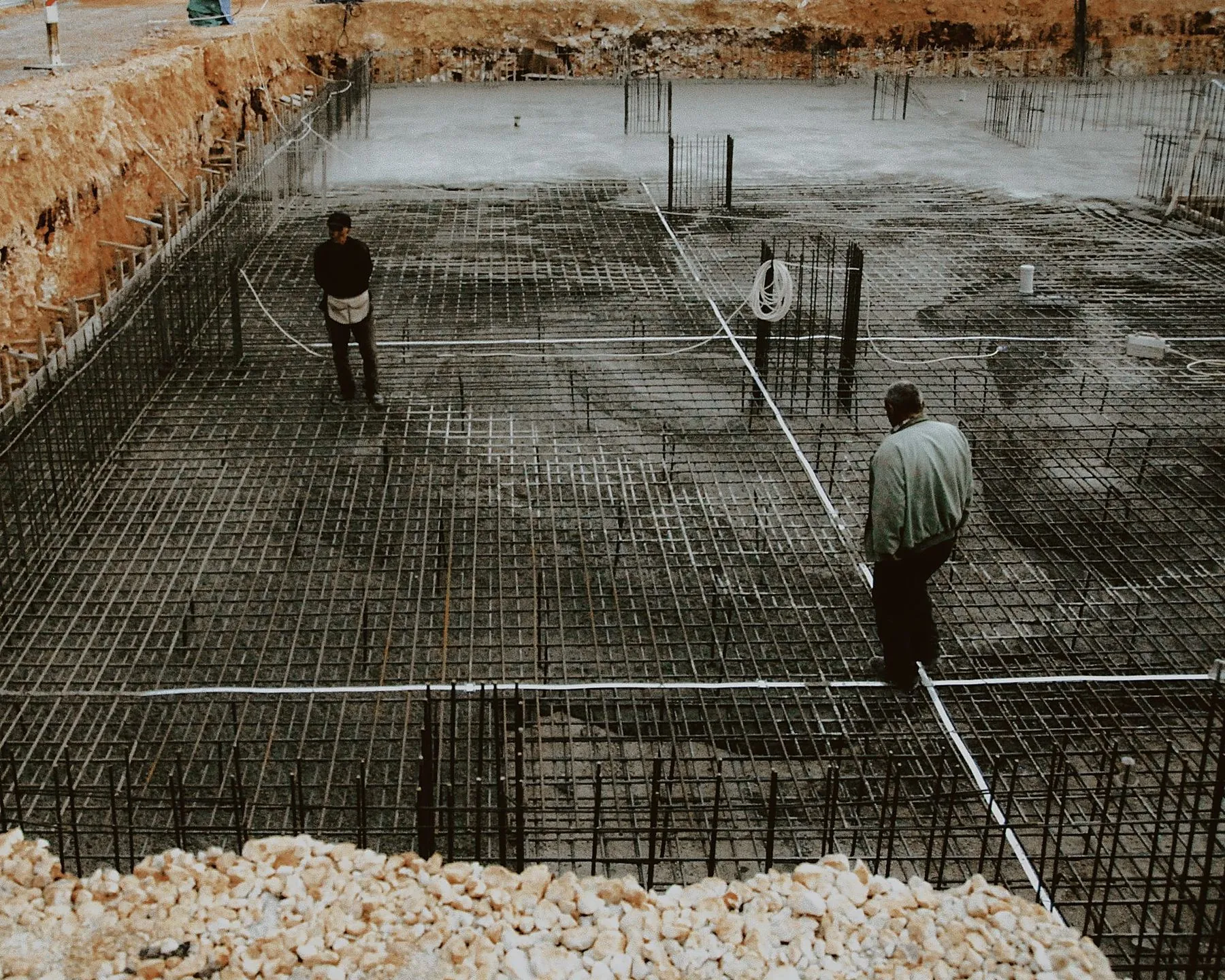 Crew inspecting a rebar mat before a foundation pour
